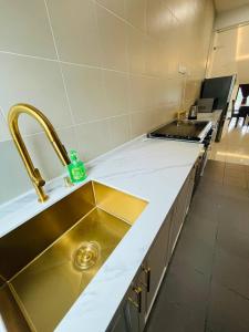 a kitchen with a sink and a counter top at Homestay 3BR near Setia Alam in Shah Alam