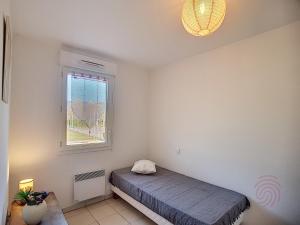 sypialnia z łóżkiem i oknem w obiekcie Appartement Lamalou-les-Bains, 3 pièces, 3 personnes - FR-1-451-133 w mieście Lamalou-les-Bains