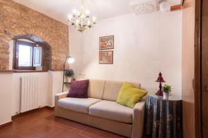 - un salon avec un canapé et une table dans l'établissement City Center Apartments - Happy Rentals, à Spello