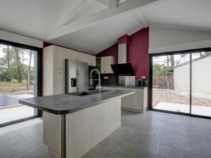 a kitchen with a large island in the middle at Villa 5 chambres à Biscarrosse avec piscine chauffée, wifi, proche océan - FR-1-521-18 in Biscarrosse-Plage