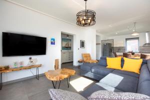 a living room with a blue couch and a tv at Apartments Villa Padrone with pool - perfect for families! in Garica