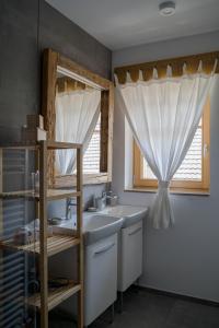 a bathroom with a sink and a window at SKED'N in Bled