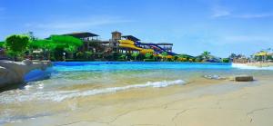 a water park with a water slide on a beach at Pickalbatros Jungle Aqua Park - Neverland Hurghada in Hurghada