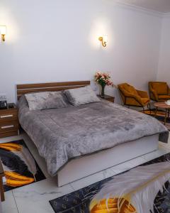 a bedroom with a large bed and two chairs at Reef Zefta Hotel in Zefta