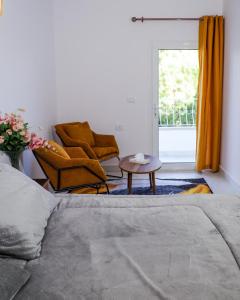 a living room with a couch and a chair and a window at Reef Zefta Hotel in Zefta