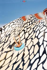 a man laying on a raft in a swimming pool at Pickalbatros Jungle Aqua Park - Neverland Hurghada in Hurghada