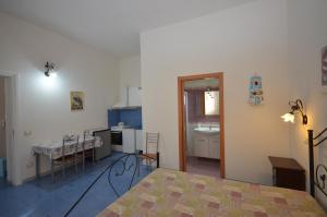 a kitchen with a table and a dining room at Appartamenti da Clarissa in Macari