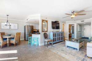 a living room with a couch and a table at Phoenix Vll 1002 in Orange Beach