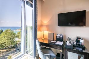 an office with a desk with a computer and a large window at Hotel Park Split in Split