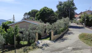 a small house with trees on the side of a road at Alloggio turistico Monte Santa Maria in Poggio Nativo