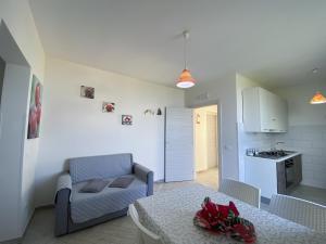 a living room with a couch and a table at Appartamenti da Clarissa in Macari