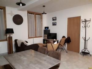 a living room with a table and chairs at Appartement Mont-Dore, 3 pièces, 4 personnes - FR-1-415-77 in Le Mont-Dore
