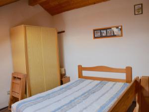 a bedroom with a bed and a wooden cabinet at Studio Bernex, 1 pièce, 4 personnes - FR-1-498-36 in Bernex