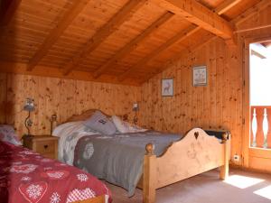 a bedroom with a bed in a wooden cabin at Chalet Bernex, 7 pièces, 16 personnes - FR-1-498-39 in Bernex