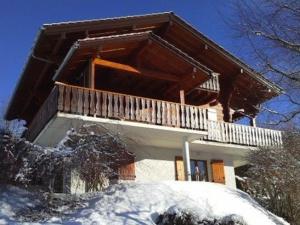 a house with a balcony in the snow at Chalet Bernex, 7 pièces, 16 personnes - FR-1-498-39 in Bernex