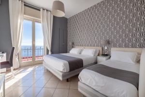 Un pat sau paturi într-o cameră la Mini Hotel - Angolo Di Paradiso -