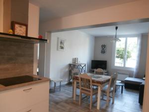 eine Küche und ein Esszimmer mit Tisch und Stühlen in der Unterkunft Charmant T3 de standing à Capbreton, jardin, 3 chambres, terrasse couverte, proche port et plages - FR-1-239-484 in Capbreton + 10 Fotos
