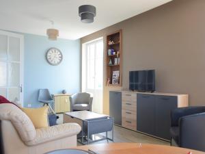a living room with a couch and a tv at Spacieux appartement à Évian-les-Bains avec balcon et garage - FR-1-498-48 in Évian-les-Bains