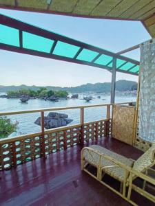 a balcony with a view of the water at El Gordo's Seaside Adventure Lodge in El Nido