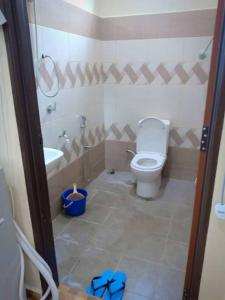 a bathroom with a toilet and a sink at Zarina's Budget Homestay in Tumpat