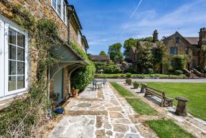 a garden with benches next to a building at Admiral's Cottage in Bridport