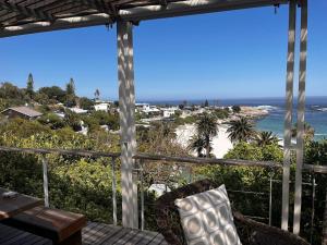 a view of the beach from the porch of a beach house at Beach House in Cape Town