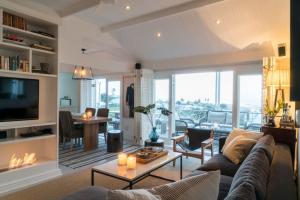 a living room with a couch and a tv at Beach House in Cape Town