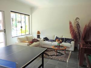 a living room with two couches and a table at Residência Familiar in Campinas