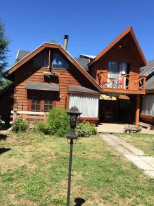 a house with a light in front of it at Cabaña Ruca Quimey in Villarrica