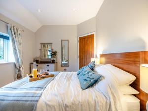 a bedroom with a bed with a tray of fruit on it at Larks Nest in Wortham