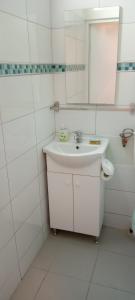 a white bathroom with a sink and a mirror at Piata Muzeului 1 in Cluj-Napoca