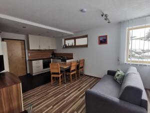 a living room and kitchen with a couch and a table at Appartement Falkner Manuel in Niederthai