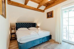 a bedroom with a bed and a large window at Vila Cornelia in Banská Štiavnica