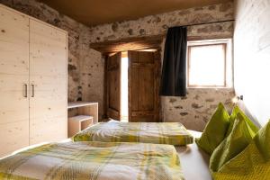 - une chambre avec un lit et une fenêtre dans l'établissement Ritschhof, à Castelrotto