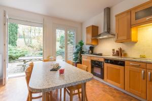 a kitchen with a table with chairs and a counter top at La Combe des Paces in Châtillon-sur-Seine