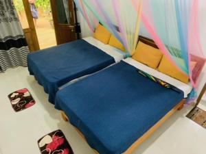 two beds sitting next to each other in a room at Quiet Rest Inn in Ella