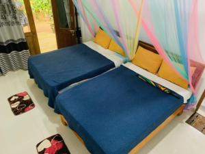 two beds sitting next to each other in a room at Quiet Rest Inn in Ella