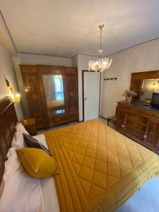 um quarto com uma cama e um lustre em Nevegal 200mt dalle piste,posto auto coperto,wifi,camino. em Nevegal