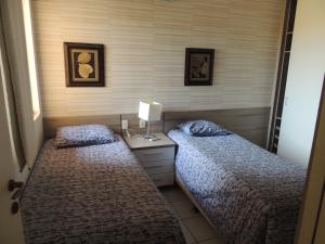 En eller flere senge i et værelse på Ap Luxo 208 e 207 Prox Beach Park