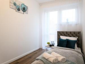 Posteľ alebo postele v izbe v ubytovaní Apartament Skandynawski