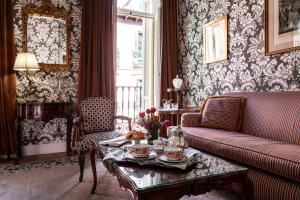 a living room with a couch and a table at Relais & Châteaux Hotel Orfila in Madrid