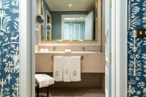 a bathroom with a sink and a mirror at Relais & Châteaux Hotel Orfila in Madrid