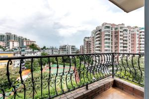 a balcony with a view of a city at Jinxinwu Aparthotel Yuancun in Guangzhou