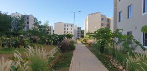 a sidewalk in a city with tall buildings at 1255 Palm Ridge Vipingo Estate Apartments in Kilifi