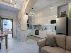 a living room with a couch and a kitchen at Luxury love nest with hot tub & heated pool in Kournás