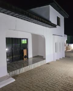 a white building with a stairway leading to a door at Eko Akete Guest House in Abeokuta