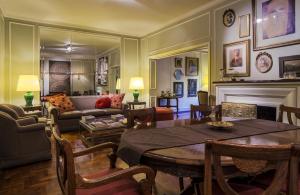 a living room with a table and a fireplace at Bed And Breakfast Plaza Italia in Mendoza