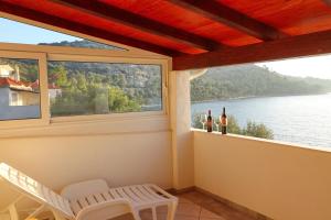 a screened in porch with a view of the water at Seafront Apartments Anthony in Lastovo