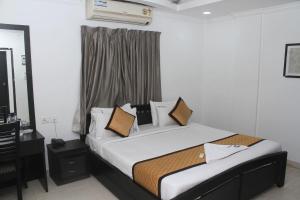 a bedroom with a large bed in a room at Skyry Residency in Chennai