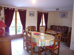 a dining room with a table and chairs at Villa de Plain-Pied avec Jardin Clos, Proche Plage et Commerces, Animaux Admis - FR-1-482-43 in Fort-Mahon-Plage +2 photos